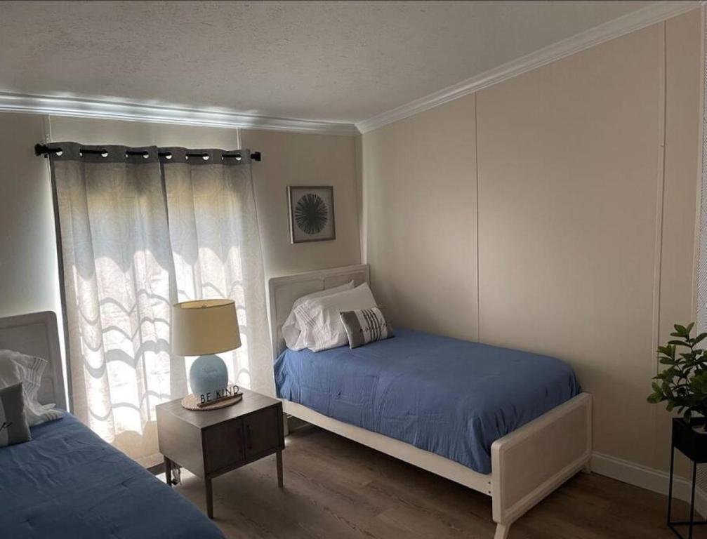 a bedroom with two beds and a window at Thomas House in Hammond