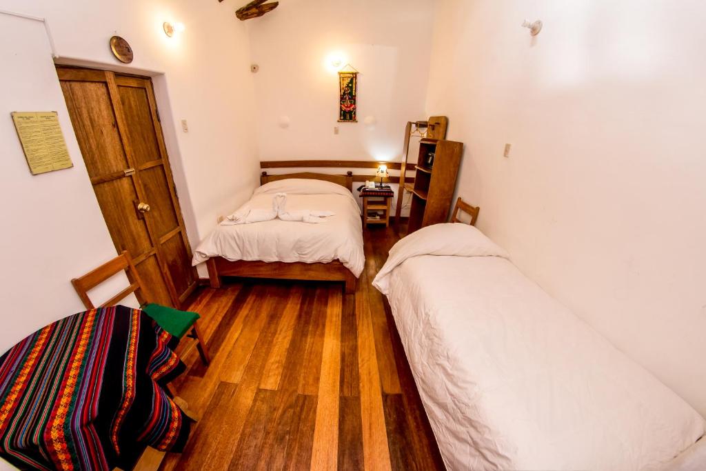Postel nebo postele na pokoji v ubytování Hostal El Grial
