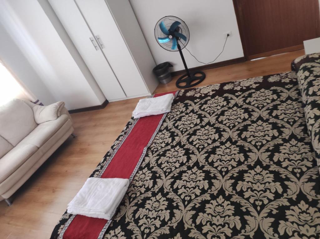 a room with a bed and a lamp and a couch at ABC Guest House in Mestre