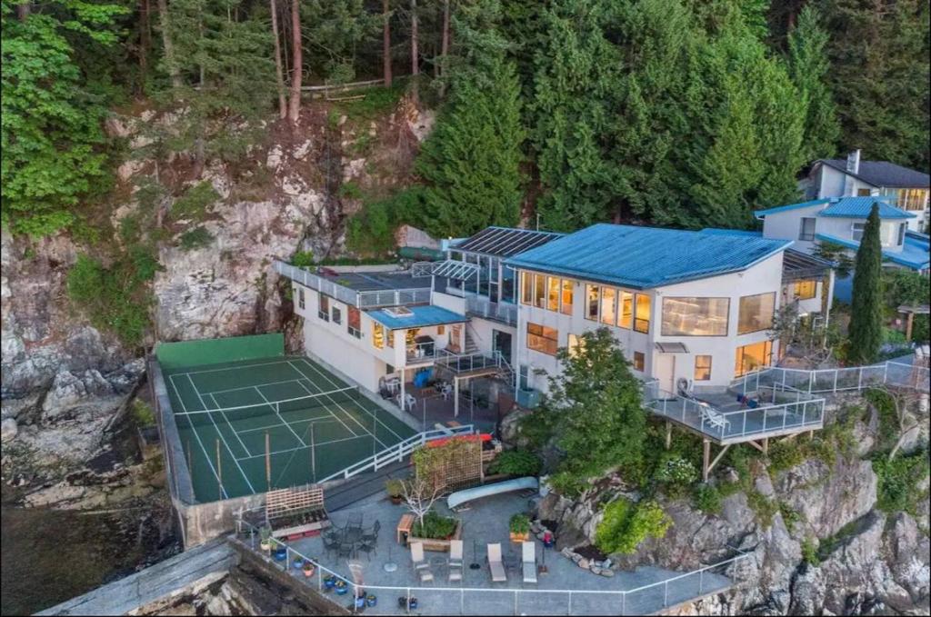 an aerial view of a house with a tennis court at Whales house in Horseshoe Bay