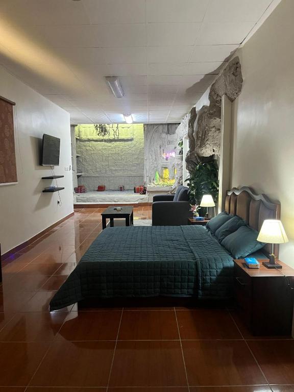 a bedroom with a bed and a living room at Studio Apartment in Abḩur al Janūbīyah