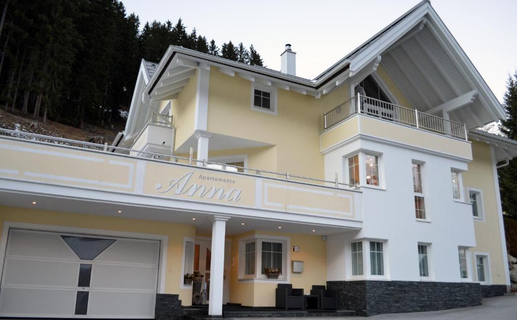 a white and yellow house with a balcony at Apart Anna in Ischgl