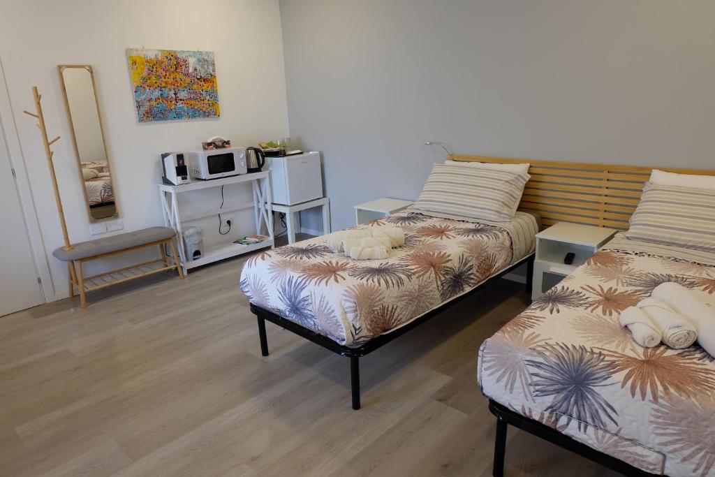 Postel nebo postele na pokoji v ubytování Adriroomsrho