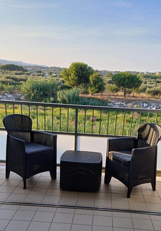 two chairs and a table on a balcony with a view at Appartamento Luigi in Alba Adriatica