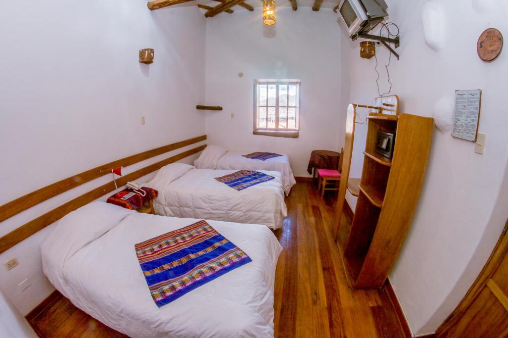 Postel nebo postele na pokoji v ubytování Hostal El Grial