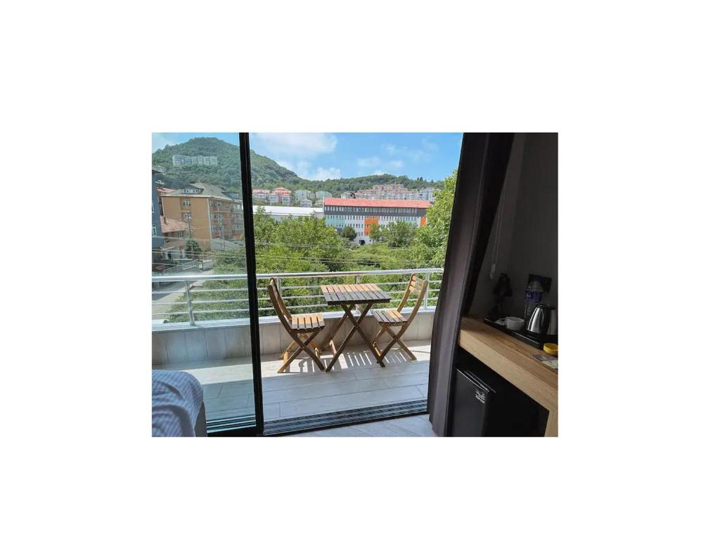 a view of a balcony with a table and chairs at Hostel Amasra in Bartın