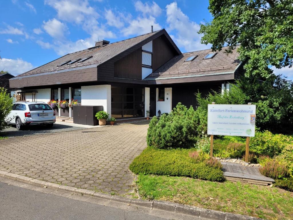 a house with a sign in front of it at Komfort-Ferienwohnung Auf der Eulenburg in Grafengehaig