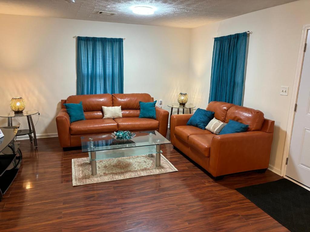 a living room with two leather couches and a table at Atlanta Quiet Private Room 2 in Atlanta