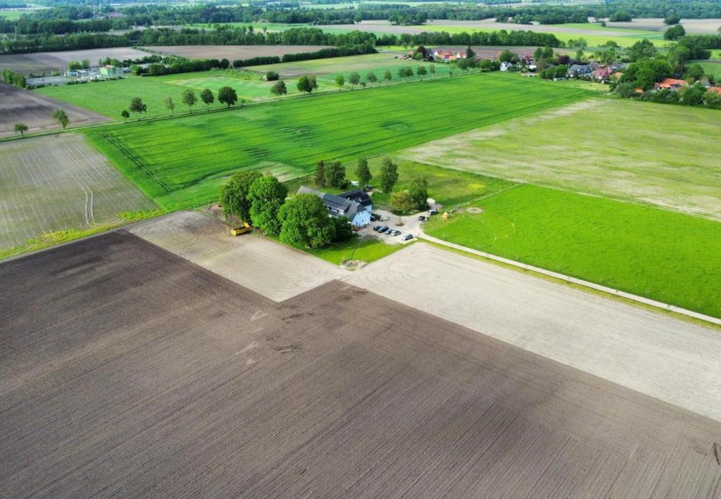 an aerial view of a field with a house and trees at Landhaus Seemann Ferienwohnungen im Grünen in Walsrode