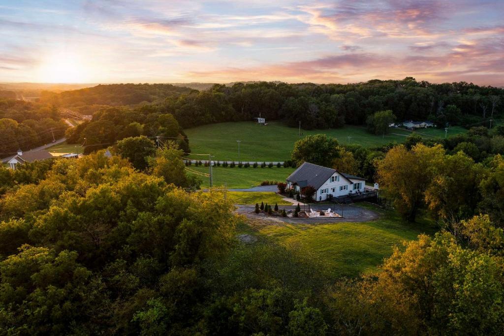 an aerial view of a house in a field at 27 South - Large Lux Retreat With Hot Tub & Gameroom in Thompsons Station