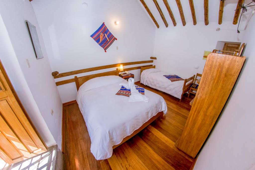 Postel nebo postele na pokoji v ubytování Hostal El Grial