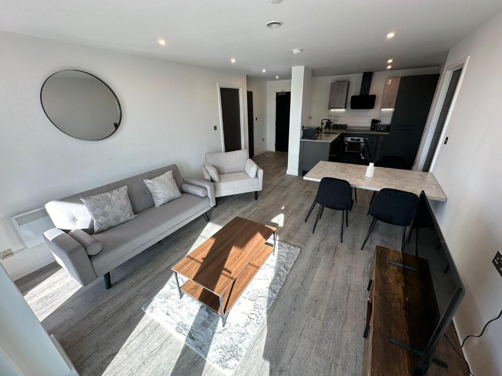 a living room with a couch and a table at Luxury central York Apartment in York