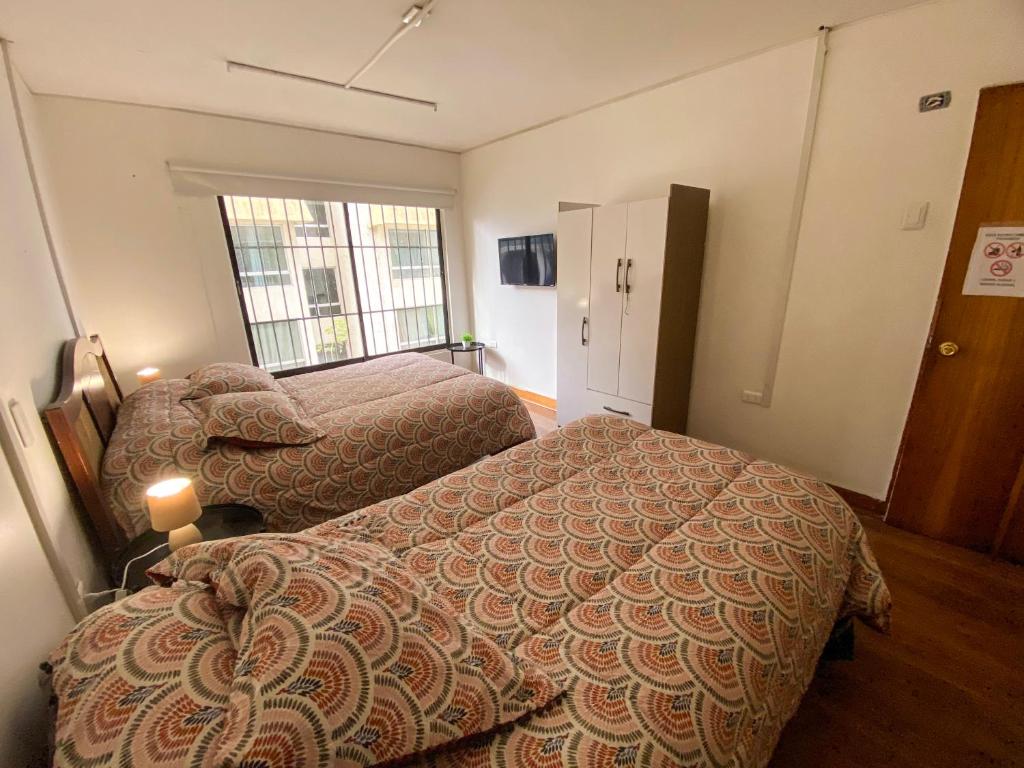 Postel nebo postele na pokoji v ubytování Hostal EntreOrientes