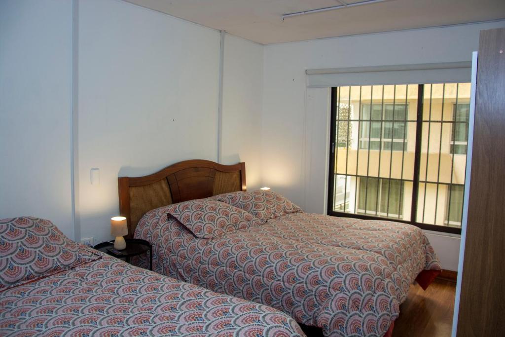 Postel nebo postele na pokoji v ubytování Hostal EntreOrientes