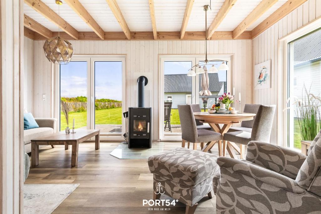 a living room with a wood stove in it at Ferienhaus Lachmöwe Olpenitz in Olpenitz