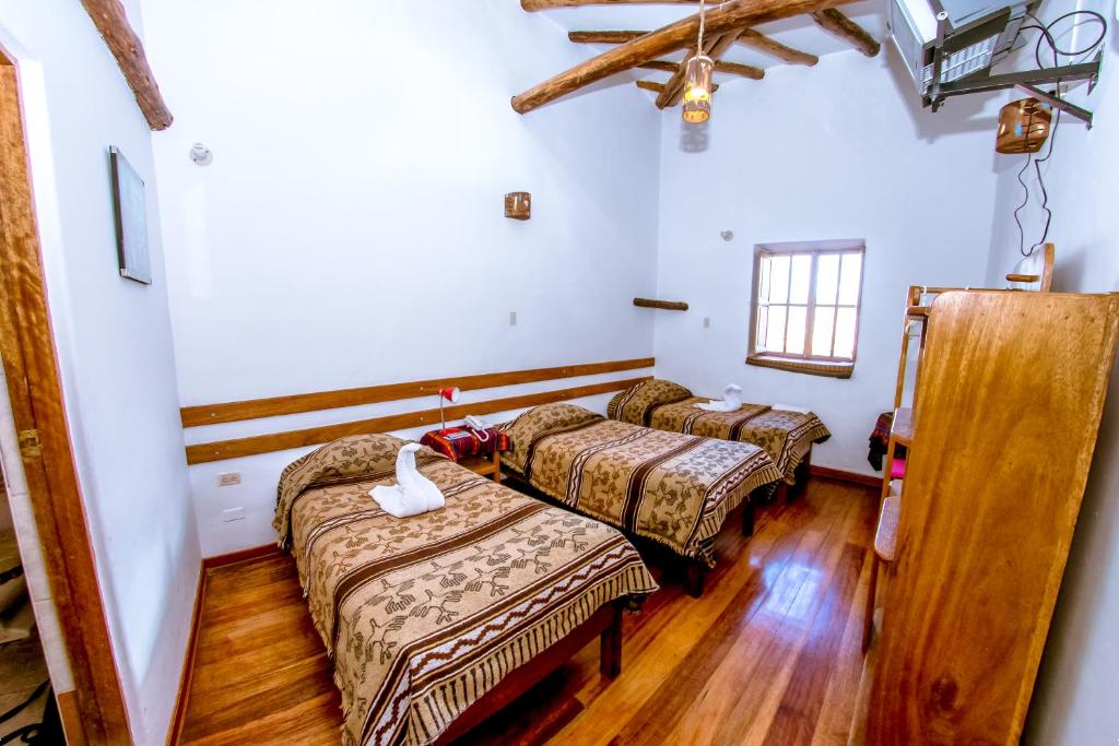 Postel nebo postele na pokoji v ubytování Hostal El Grial