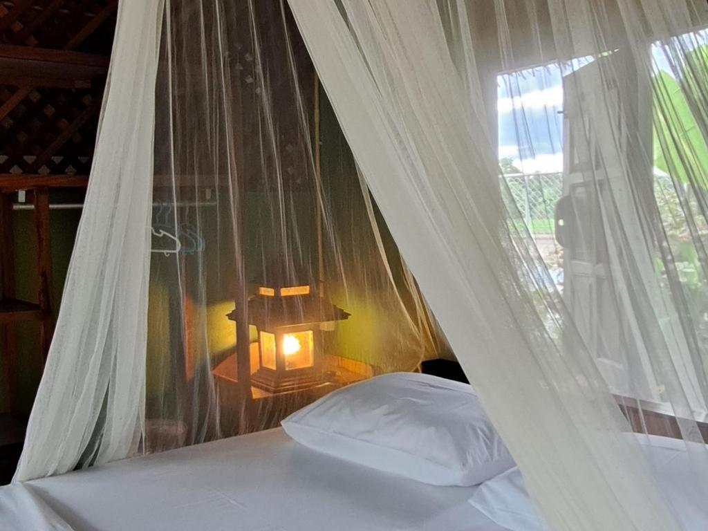 Letto o letti in una camera di Kham Ecolodge