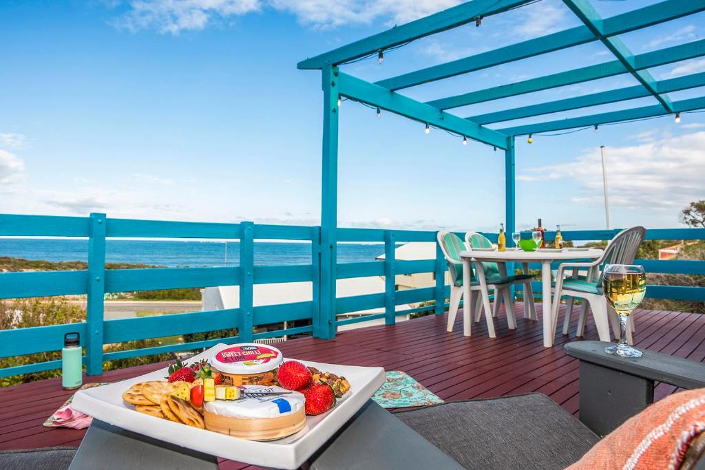 a tray of food on a table on a deck with the ocean at Blue View - UNINTERRUPTED OCEAN VIEWS FOR MILES in Guilderton