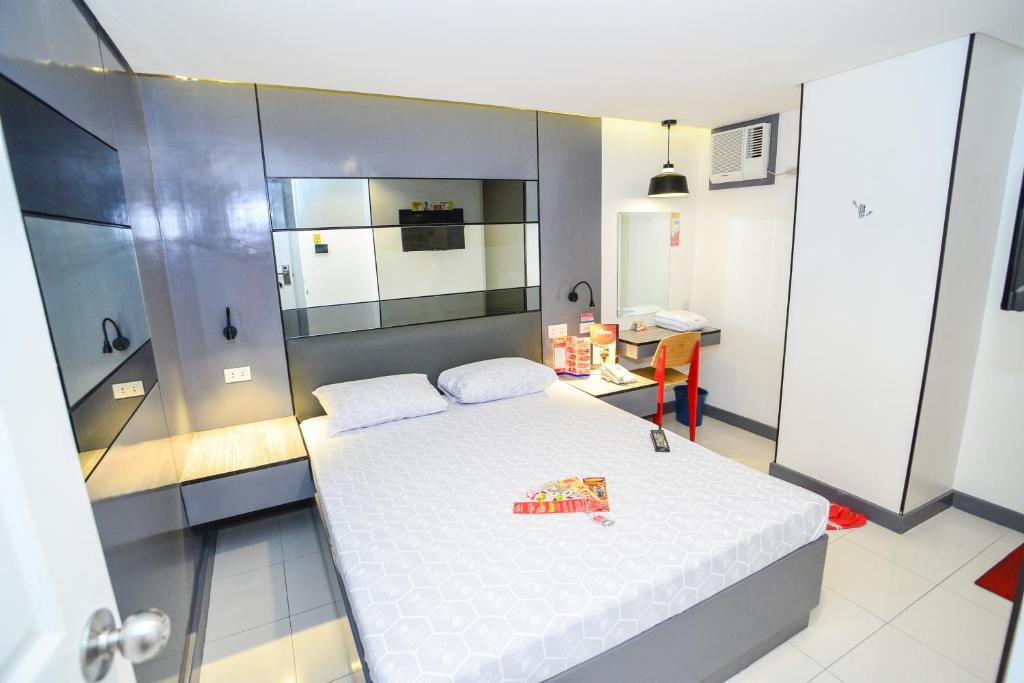 Postel nebo postele na pokoji v ubytování Hotel Sogo Davao