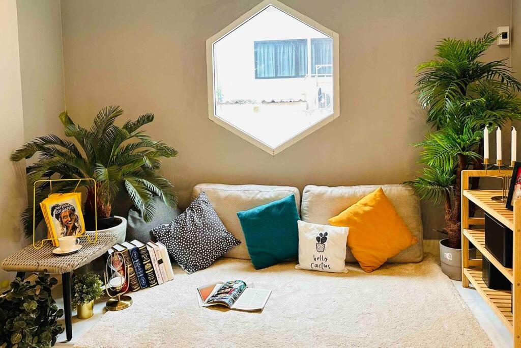 a living room with a couch with colorful pillows at 5BRHouse City centre Silom 3min to BTS Saint Louis in Bangkok