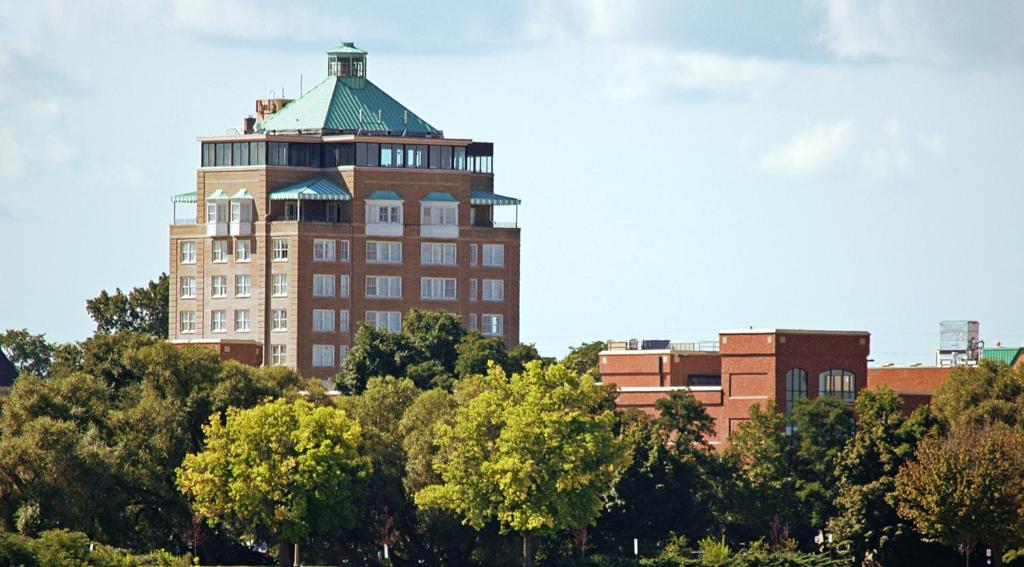 a tall building with a green roof on top of trees at Park Place Hotel & Conference Center in Traverse City