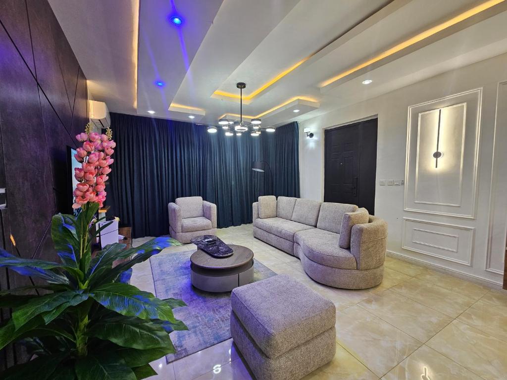 a living room with two couches and a table at Genesis Grid Homes - Petra in Lekki