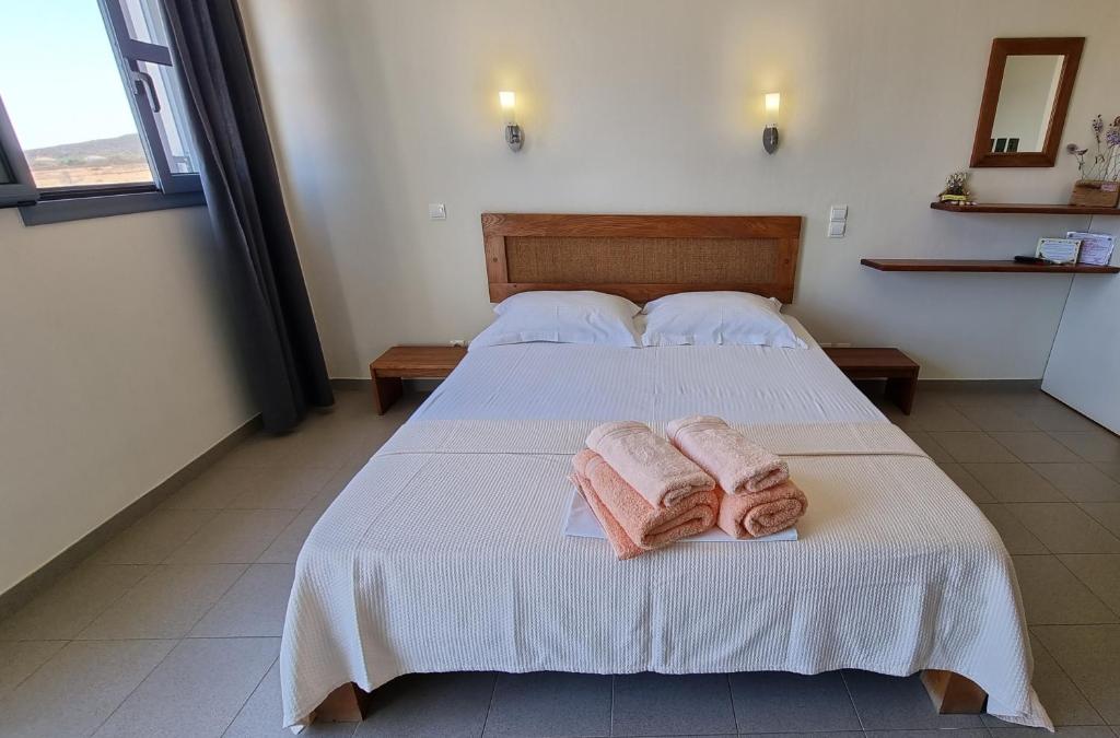 a bedroom with two towels on a bed at Domatia me Thea in Elafonisos