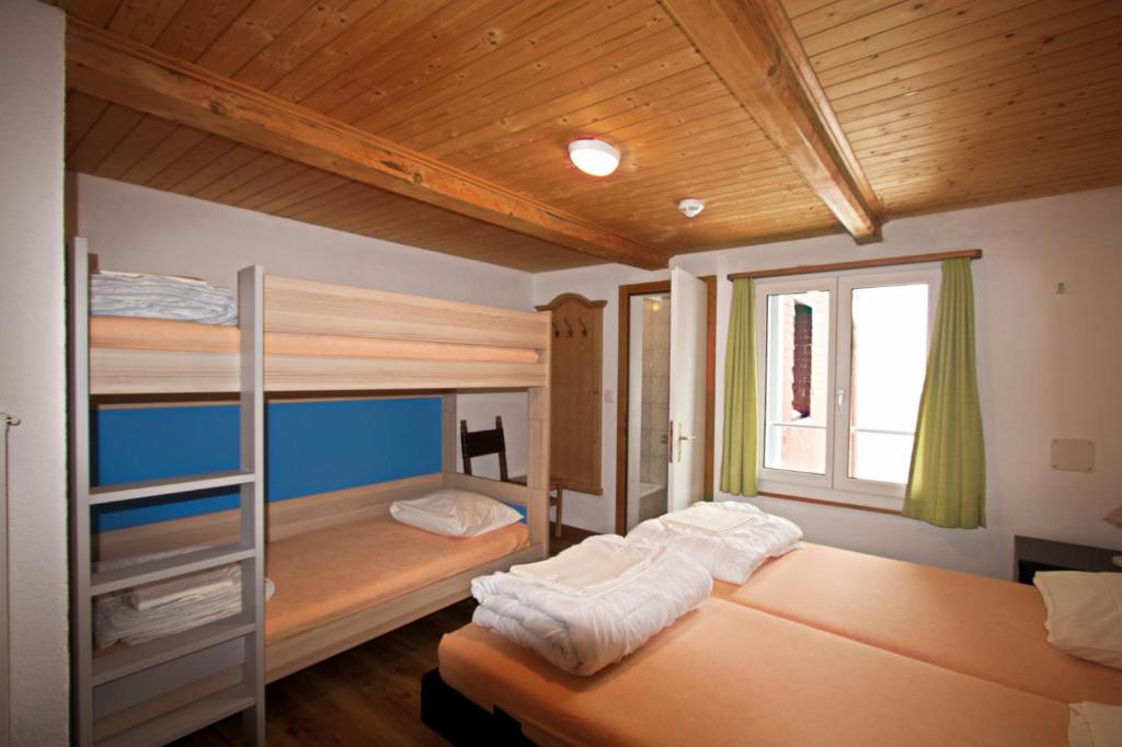 Postel nebo postele na pokoji v ubytování juhui Flumserberg