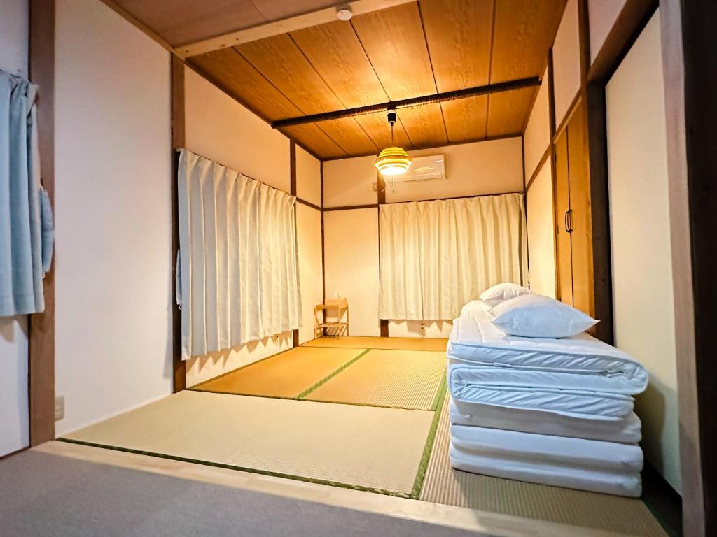 Postel nebo postele na pokoji v ubytování ファミリー仲良しグループ向け一棟貸切の宿ともだちハウス