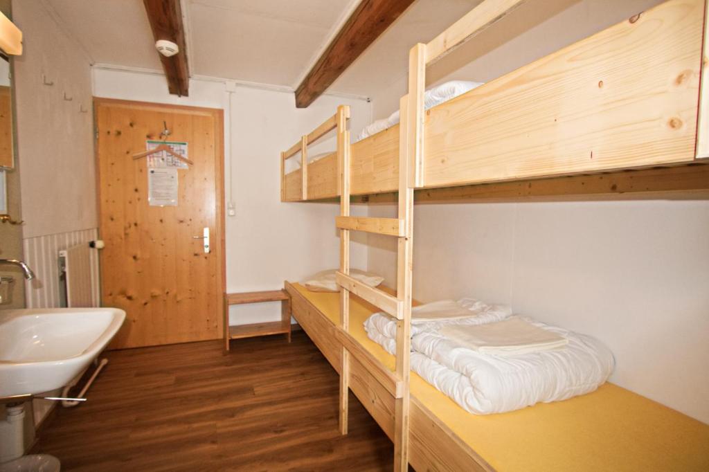 Postel nebo postele na pokoji v ubytování juhui Flumserberg