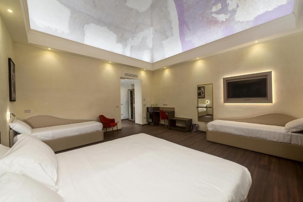 Postel nebo postele na pokoji v ubytování Hotel Vittoria