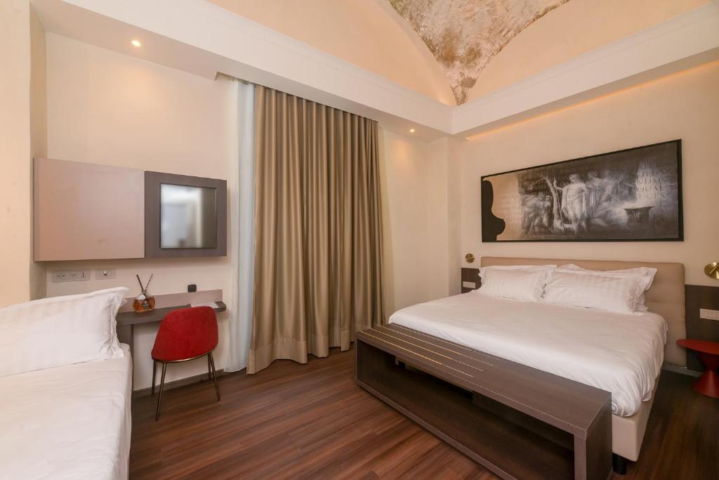 Postel nebo postele na pokoji v ubytování Hotel Vittoria