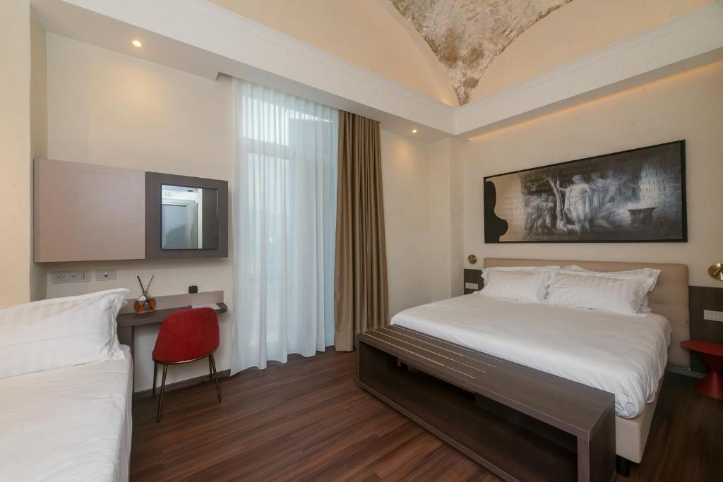 Postel nebo postele na pokoji v ubytování Hotel Vittoria