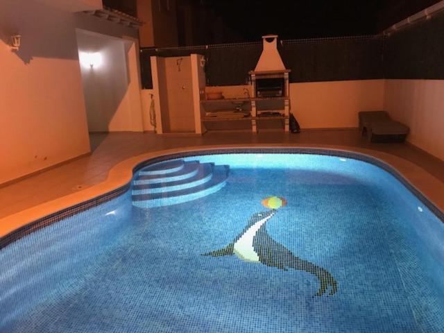 a swimming pool with a picture of a woman in it at Casa do Mar - Praia de Manta Rota in Vila Nova de Cacela