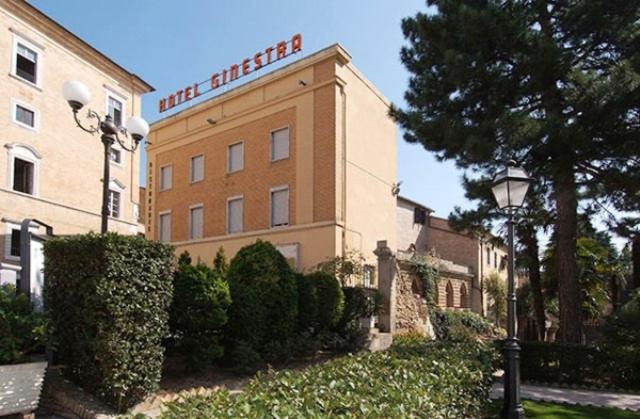 a hotel with a sign on the side of a building at Hotel Ristorante La Ginestra in Recanati