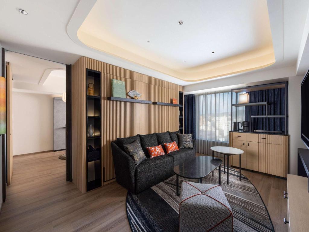 a living room with a couch and a table at Novotel Nara in Nara