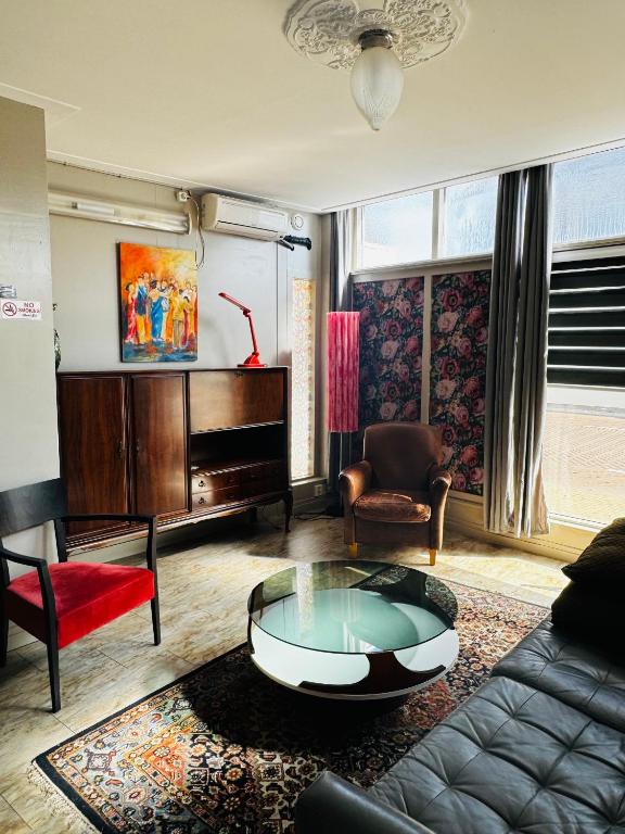 a living room with a couch and a piano at Friend zone in Zaandam