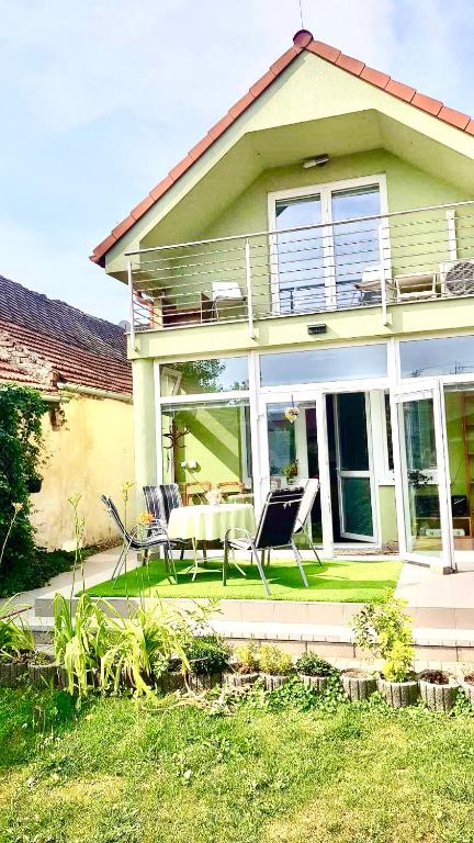 a house with a patio with a table and chairs at Apartmány Pálava Novosedly in Novosedly