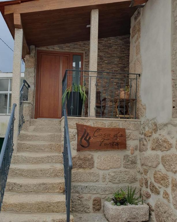 a house with a sign on the front of it at Casa da Fonte in Castro Daire