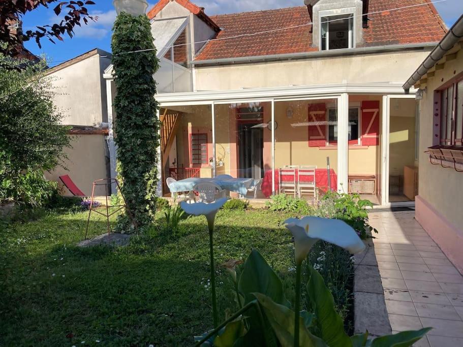 une maison avec une table dans la cour dans l'établissement Maison de ville proche du centre historique, à Bourges