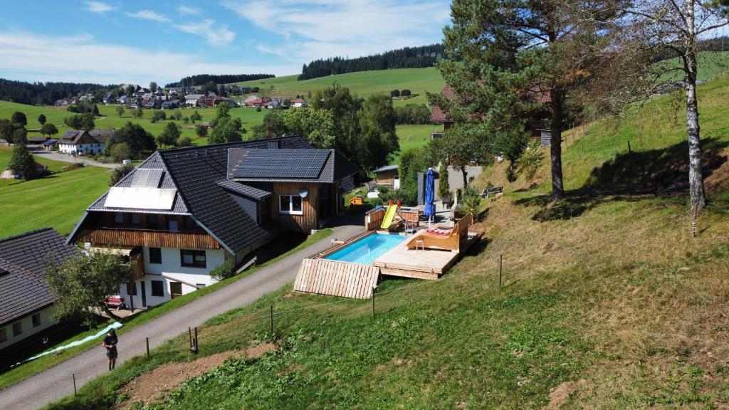 an aerial view of a house with a swimming pool at Ferienwohnungen am Schneeberg in Titisee-Neustadt