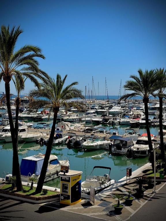 a marina filled with lots of boats and palm trees at VVVHouse in Manilva