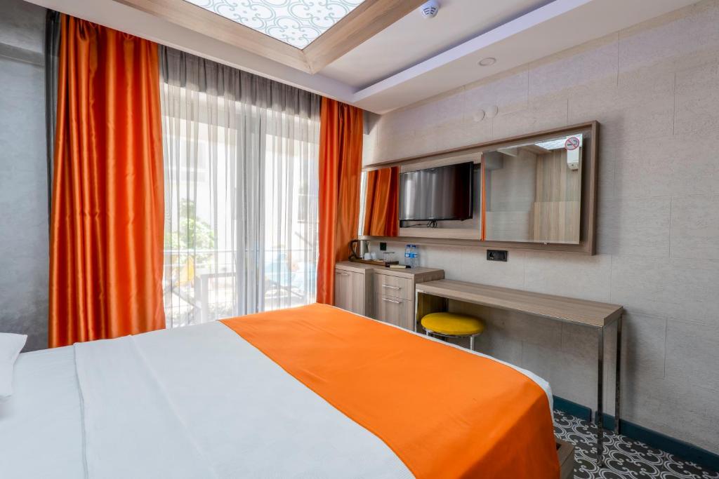 Postel nebo postele na pokoji v ubytování Erdem City Hotel