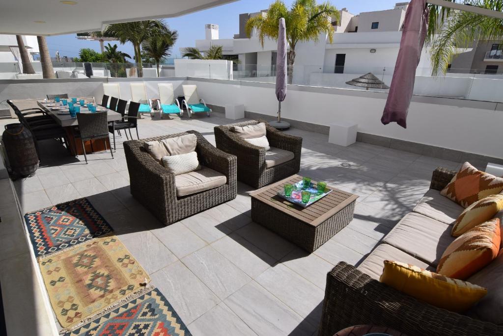 a patio with couches and a table on a roof at Dream Gardens 2 in Mijas Costa