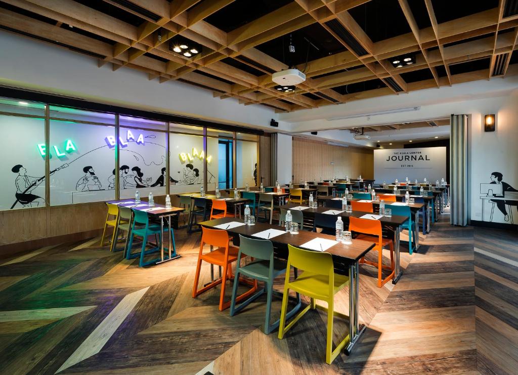 a dining room with tables and chairs at The Kuala Lumpur Journal Hotel in Kuala Lumpur