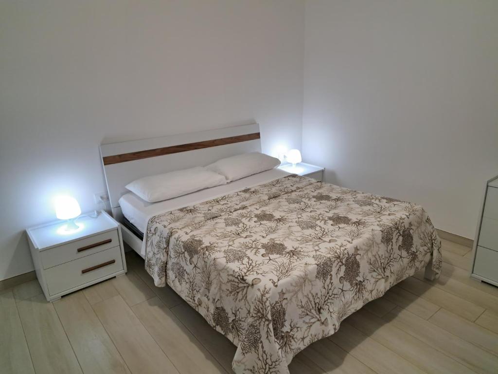 a small bedroom with a bed and two night stands at Casa Vacanze Argento in Bacoli