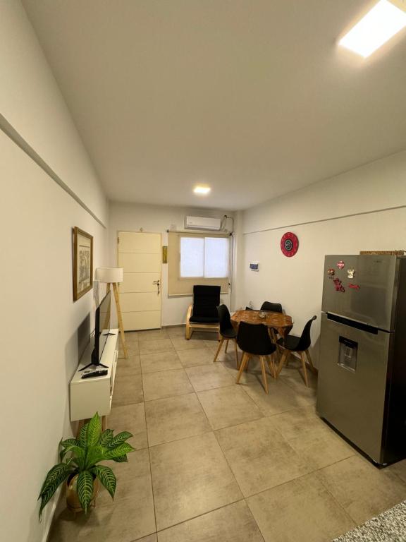 a living room with a refrigerator and a table at Hermoso y completo departamento centrico in La Rioja