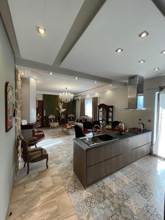 a large living room with a kitchen and a living room at Balcony With A View in Nafplio