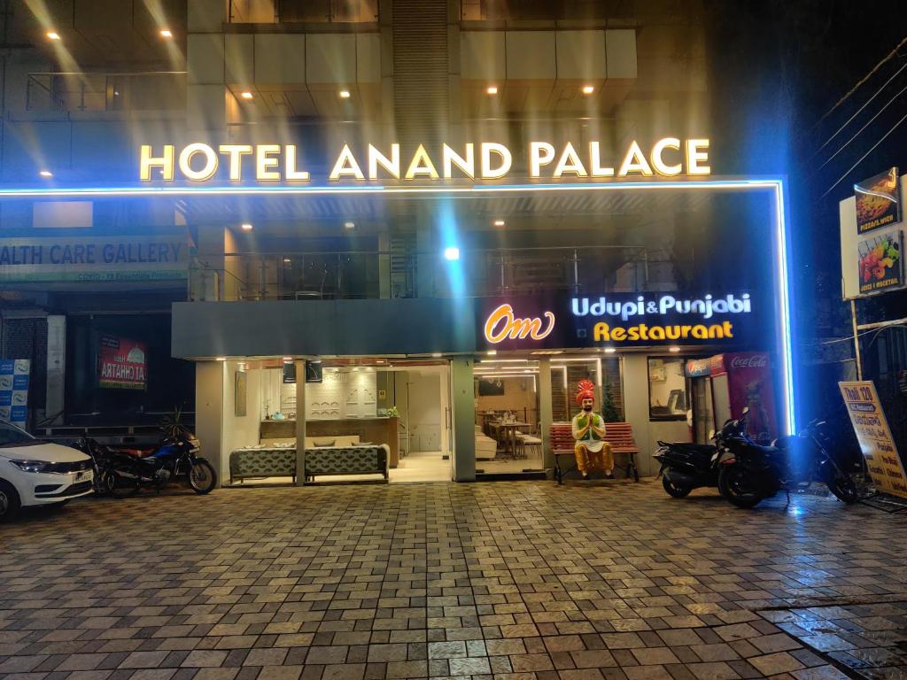 a hotelanimal island palace sign on the side of a building at Hotel Anand Palace in Shirdi