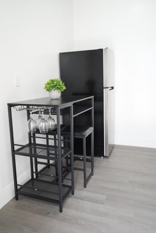a black table with a plant on it next to a refrigerator at Luxury apartment 1 in Tampa